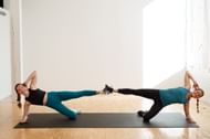 Partner workout of the day (Image via Getty Images)